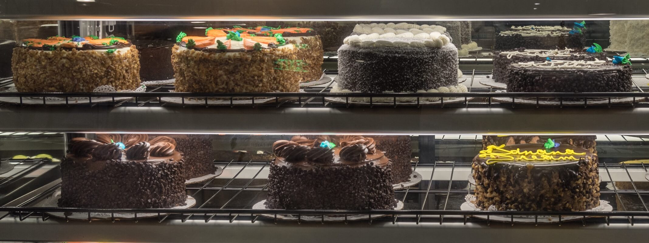 Gourmet specialty cakes in a display case