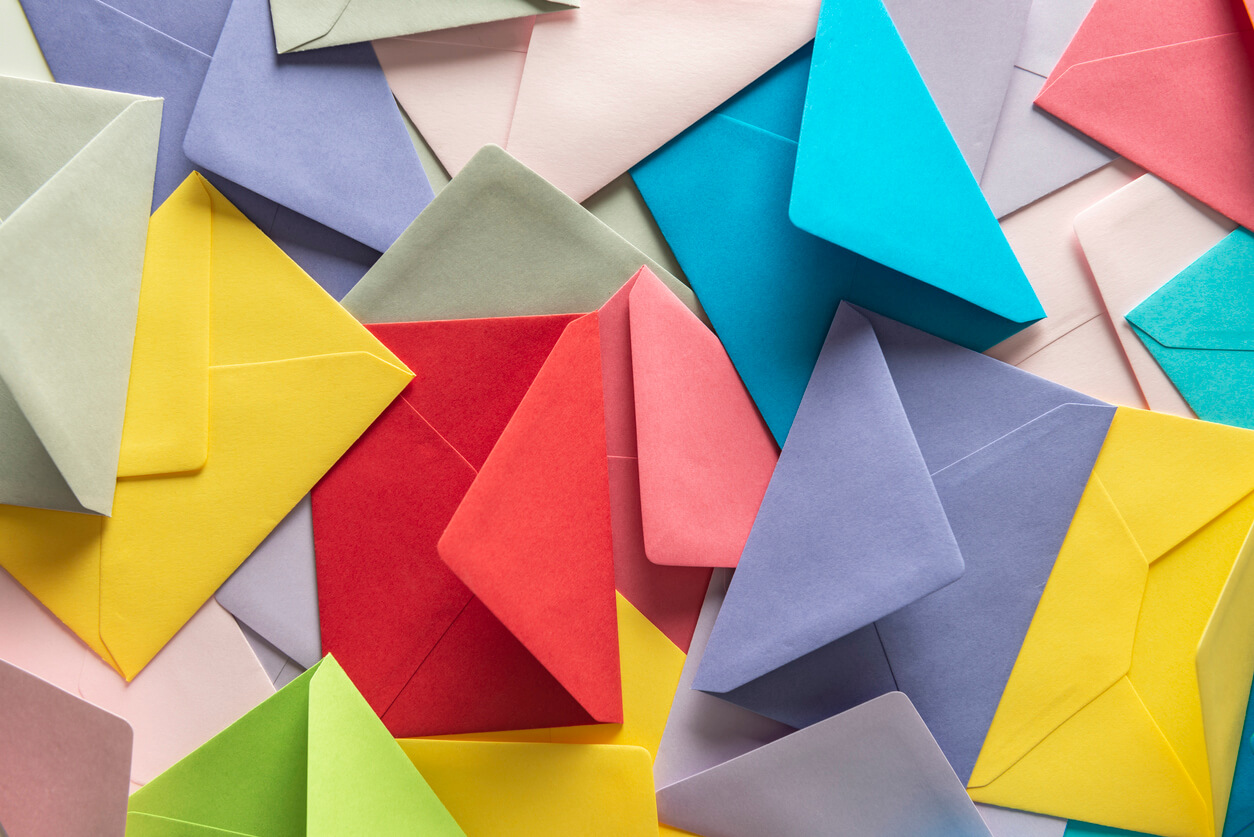 Scattered, colorful event invitation envelopes for your next catered event