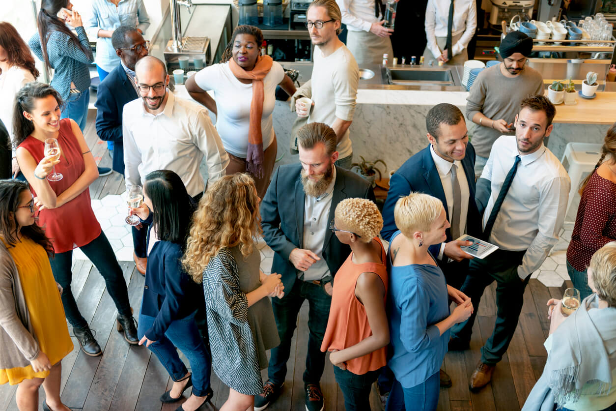 A diverse group of employees mingling at an inclusive work party
