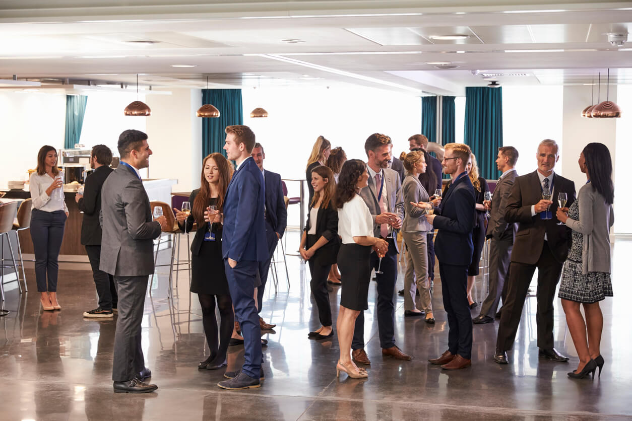 Employees mingling with food and drink at a corporate event