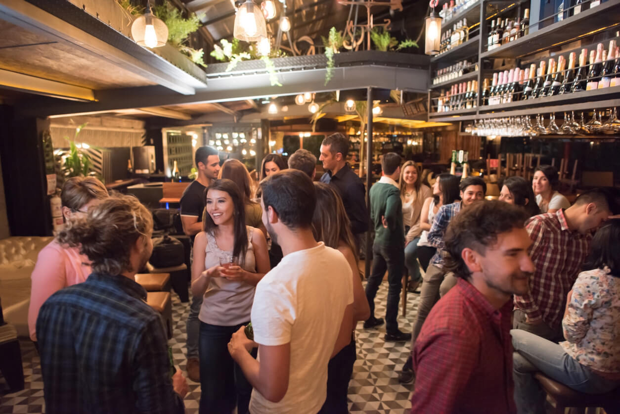 People mingling at a bar after choosing an event venue