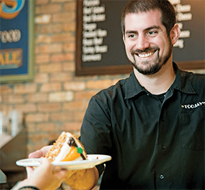 A photo of a smiling employee at TooJay's